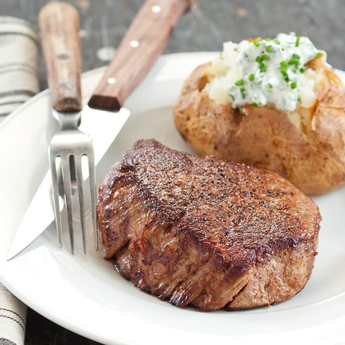 Beef Tenderloin Steaks with Chive Baked Potatoes | Cook's Country