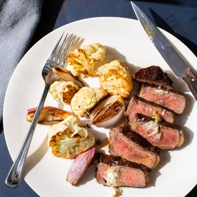 Strip Steaks with Cauliflower and Roasted Garlic Butter America's