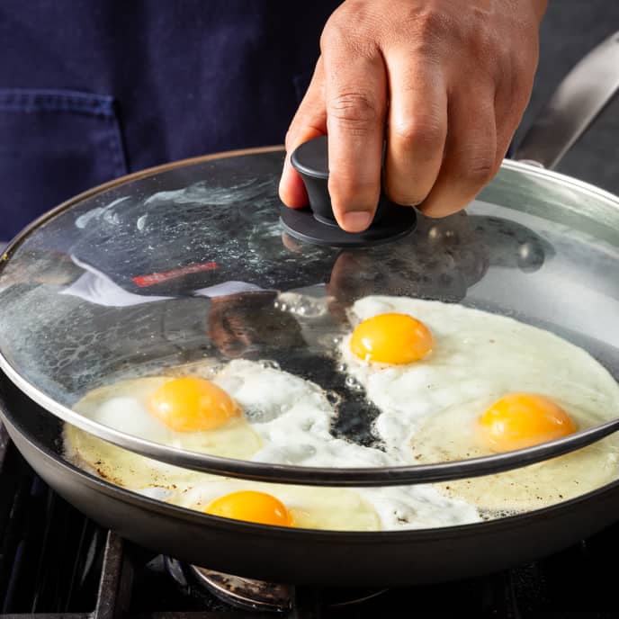 Why are frying pans higher in the middle so that things like eggs