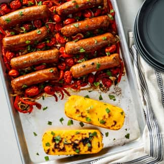 Sheet-Pan Plant-Based Italian Sausage with Peppers, Onions, Tomatoes, and Polenta