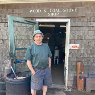 Emery Pineo posing in front of his shop