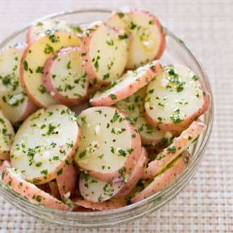 Slices of red potatoes with herb dressing