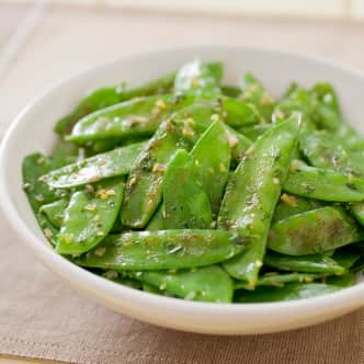 snow peas in bowl with minced shallot