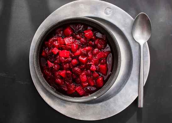 Cranberry sauce in a silver serving bowl with a spoon