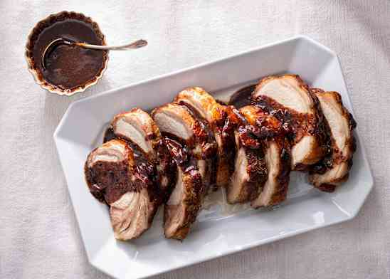 Slow-roasted bone-in pork rib roast on a cutting board