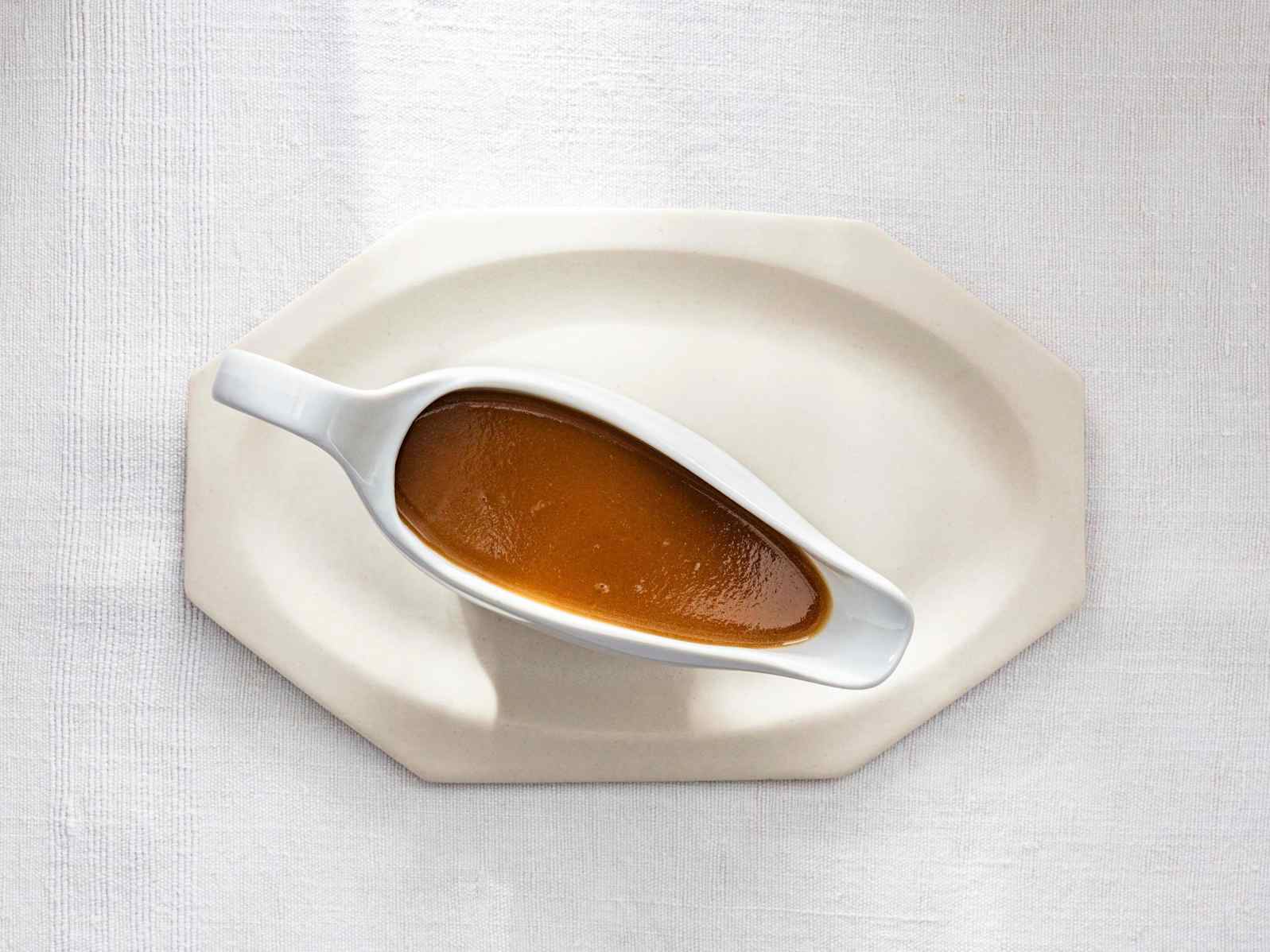 Golden brown gravy in a white gravy boat
