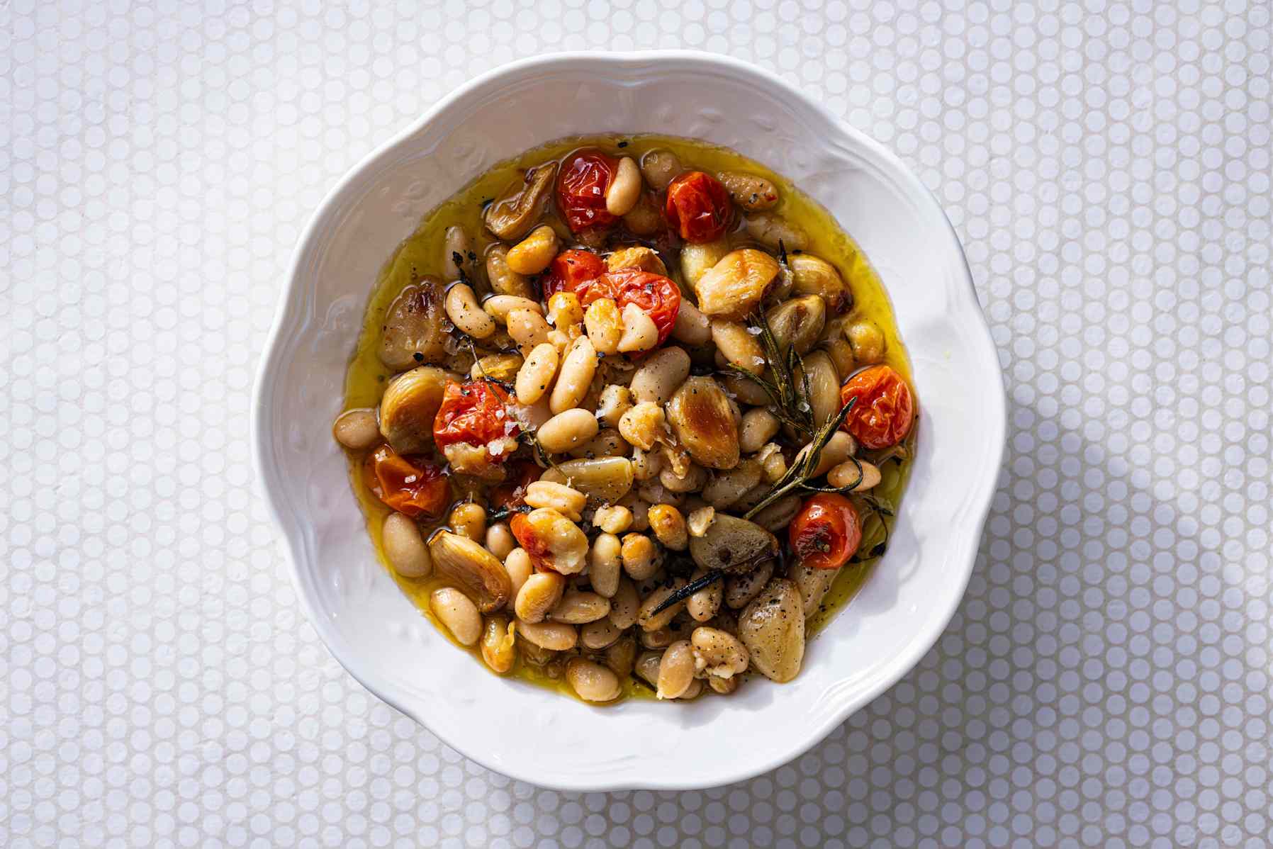 Confit Beans with 40 Cloves of Garlic in a white bowl