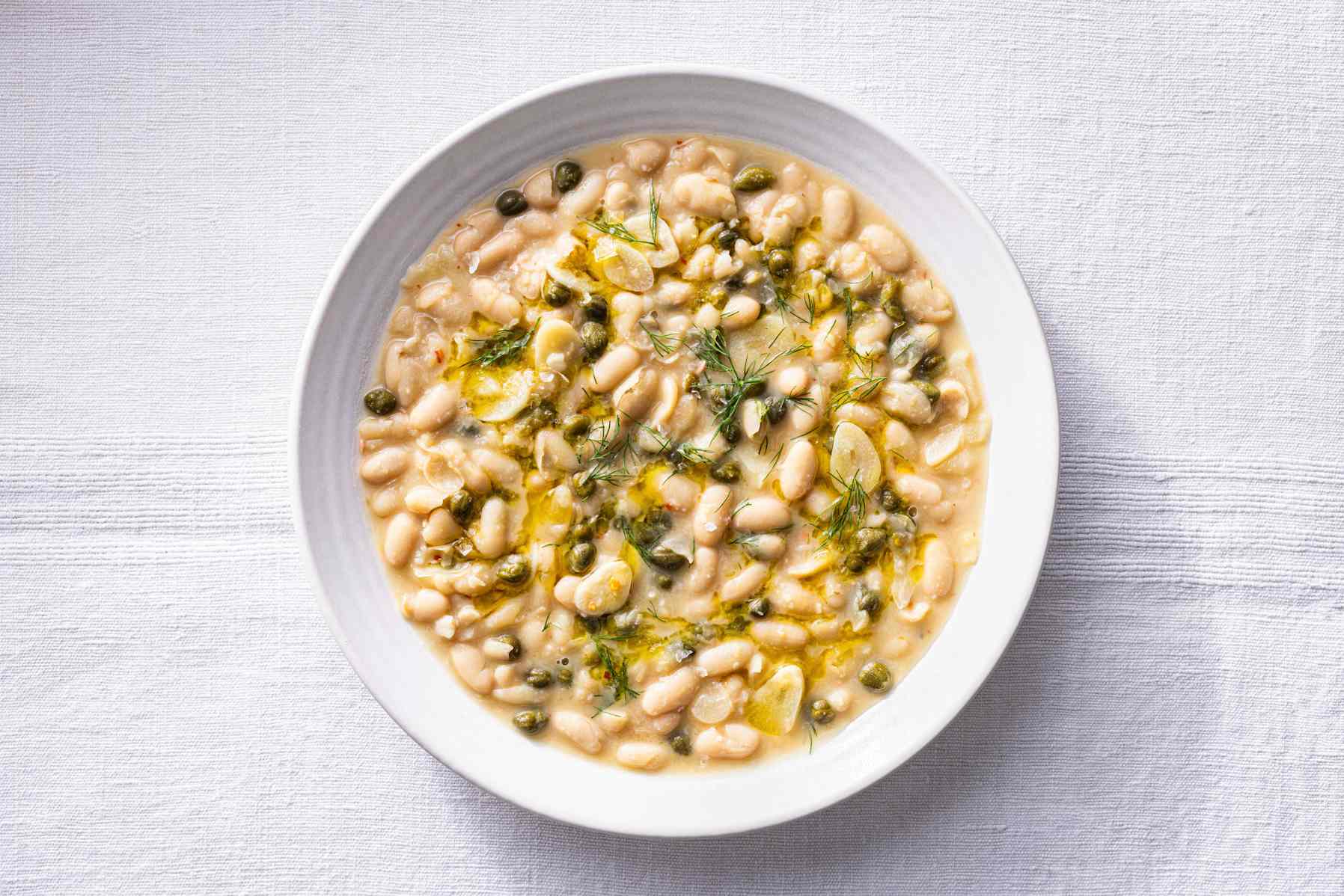 Piccata beans in a white bowl