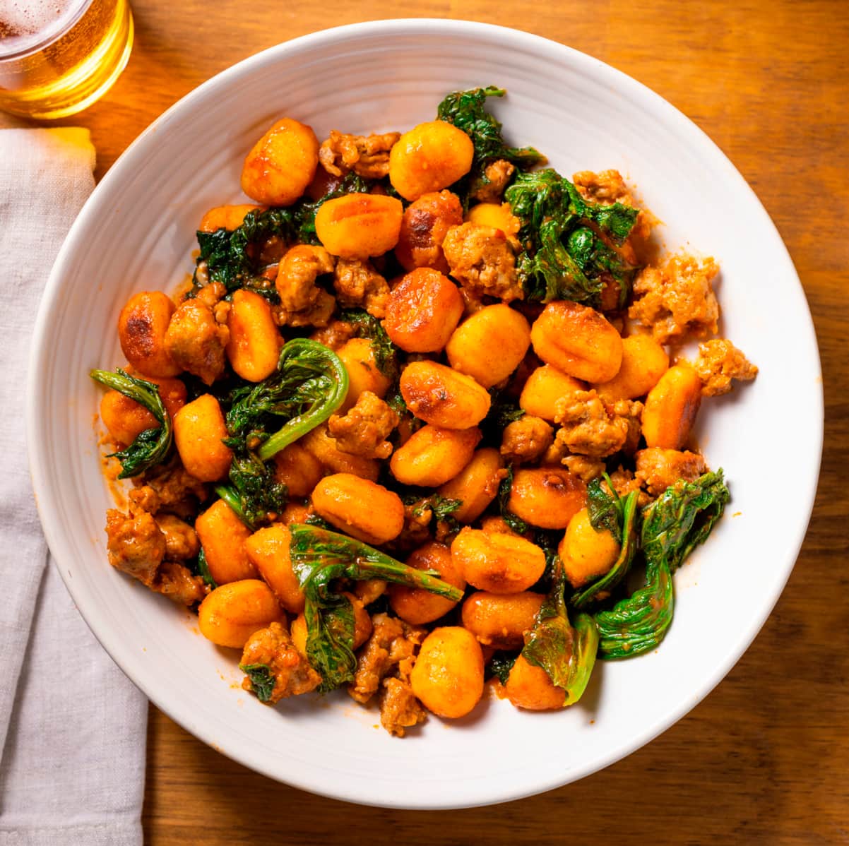 Crispy Gnocchi with Gochujang, Sausage, and Mustard Greens