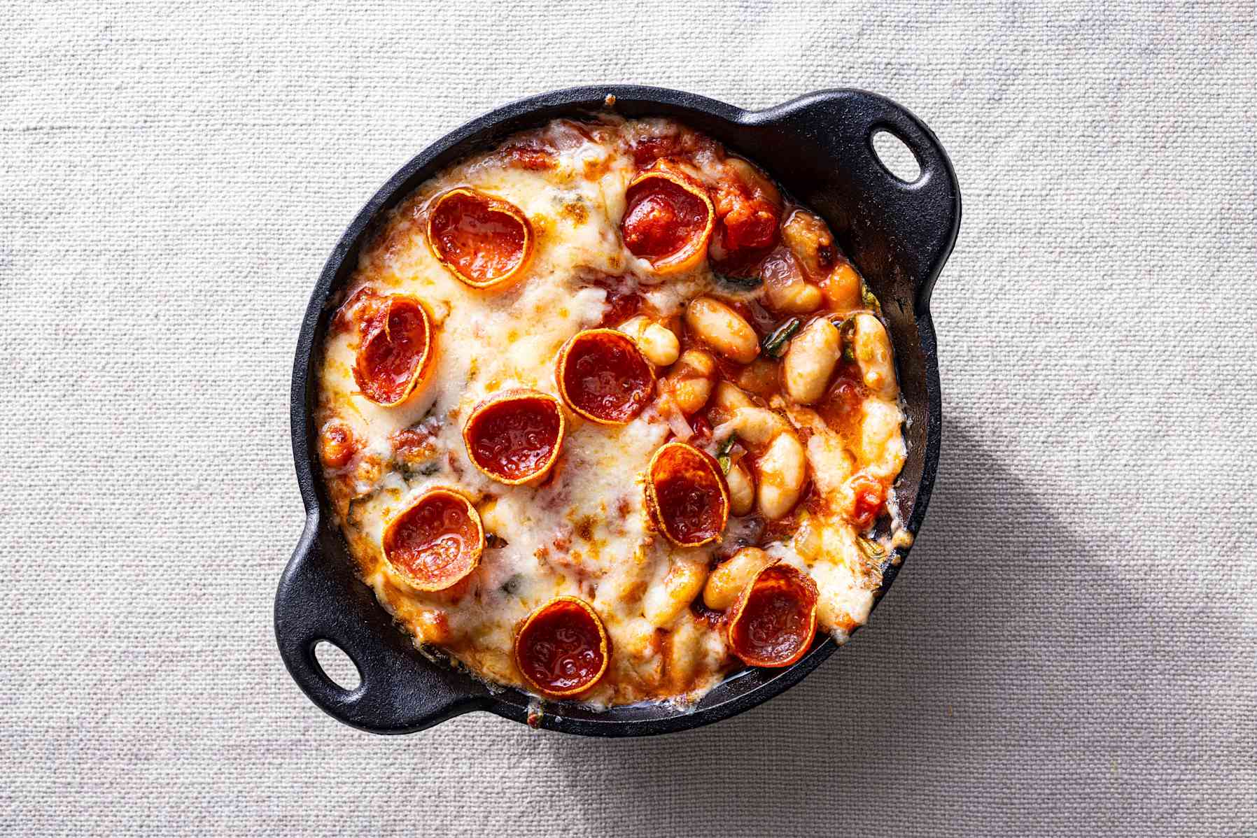 Pepperoni pizza beans in a cast-iron skillet