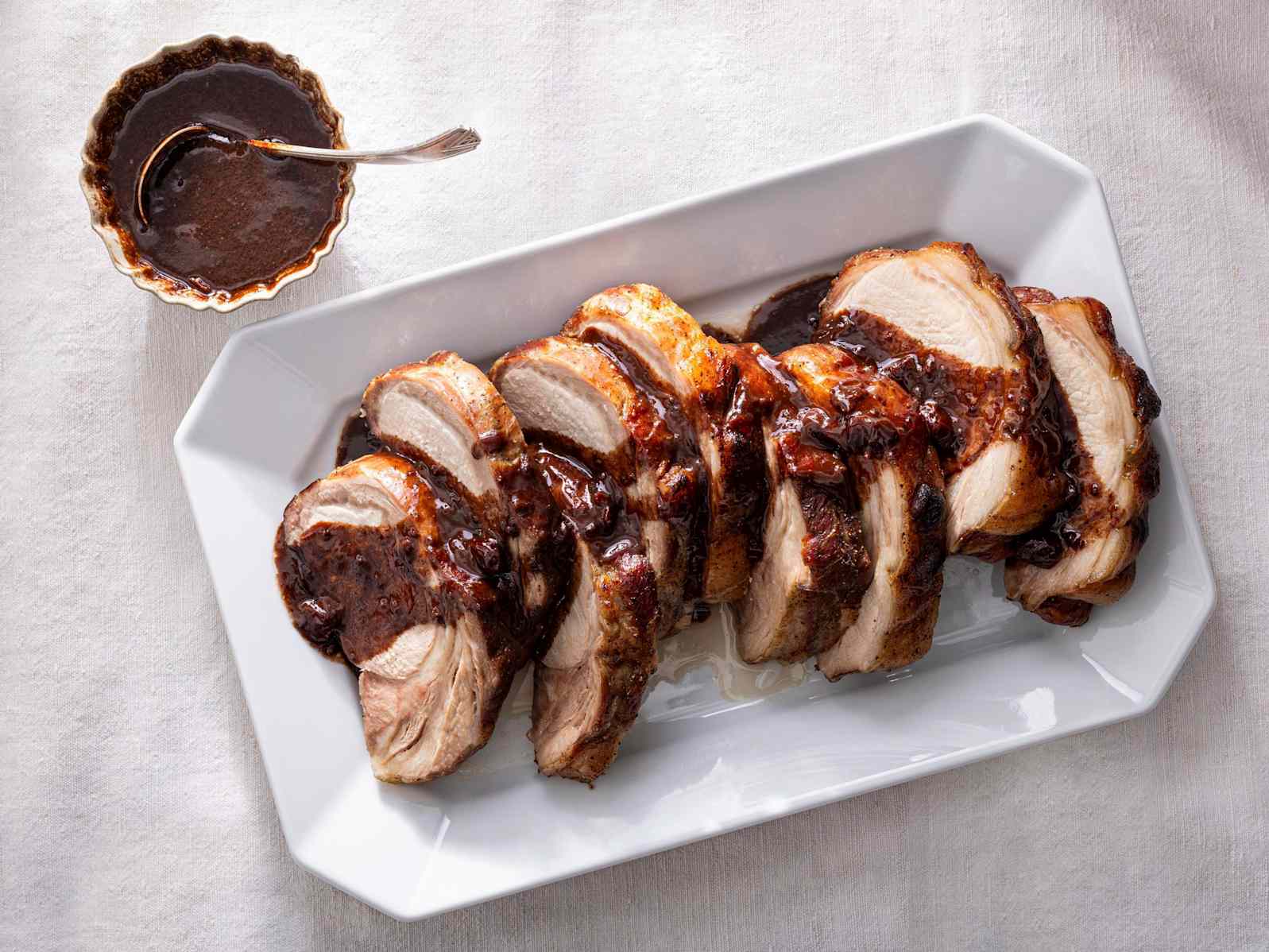 Slow-roasted bone-in pork rib roast on a cutting board
