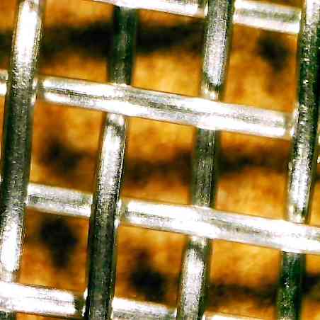 Close up of metal strands that make up traditional splatter screens. 