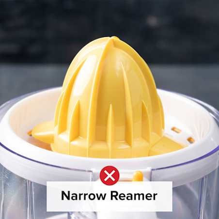A yellow reamer featuring no sharp tip in the center of a white and transparent juicer.