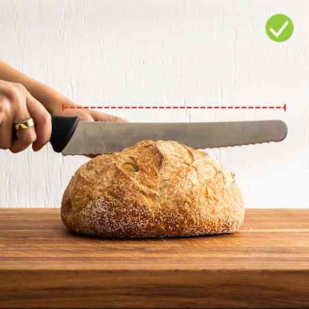 A bread knife that’s longer than a big round bread loaf and able to slice it.