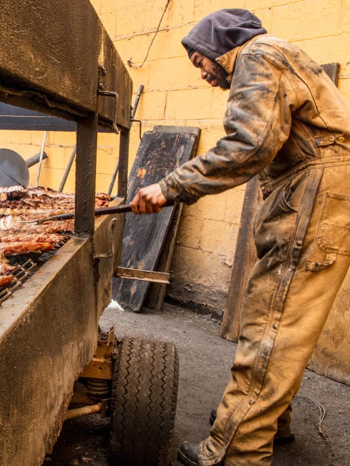Quashon Campbell tends to a grill loaded with ribs at Hot Sauce Williams Barbecue in Cleveland, Ohio (this establishment is now permanently closed.)