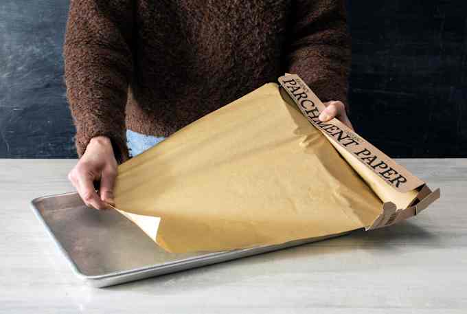 A floppy, bendy box dispenses a wrinkly sheet of parchment.