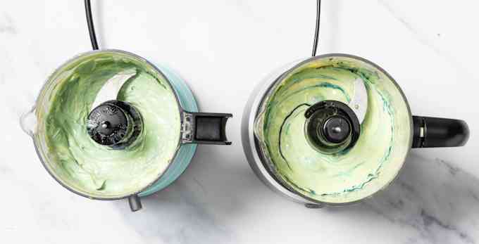 Overhead image of two food processors making mayonnaise. Food coloring has been added to show how well the ingredients have been incorporated. 