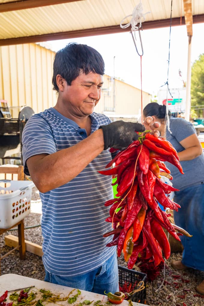 Soto Guadelupe holding bushel of chili peppers