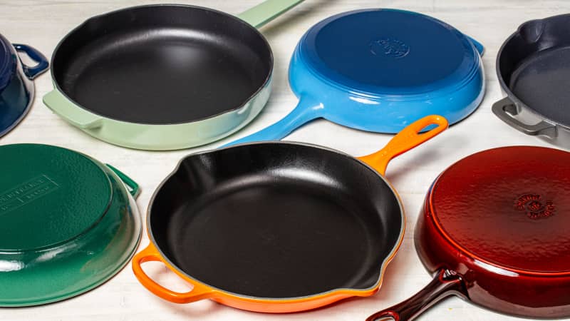 a collection of enameled cast iron skillets