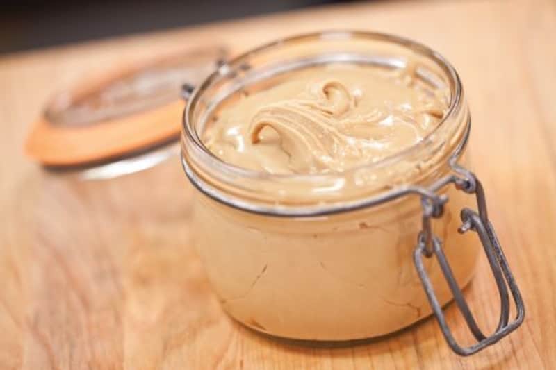 Flip-top mason jar full of thick, light brown maple cream. 