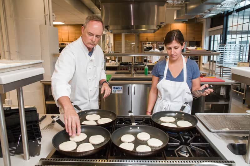 Two test cooks working side by side making pupusas for a Five-Recipe Test