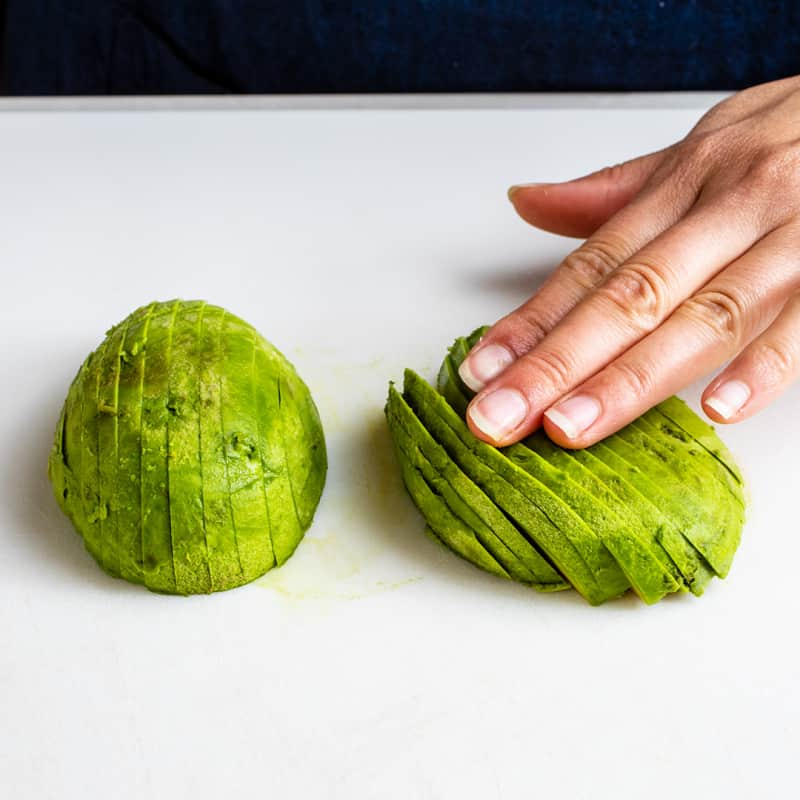 Gently press slices down with your hand in 1 direction to the right so the slices fan out.