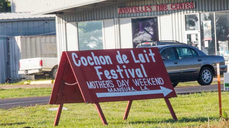 A sign announcing the Cochon de Lait Festival