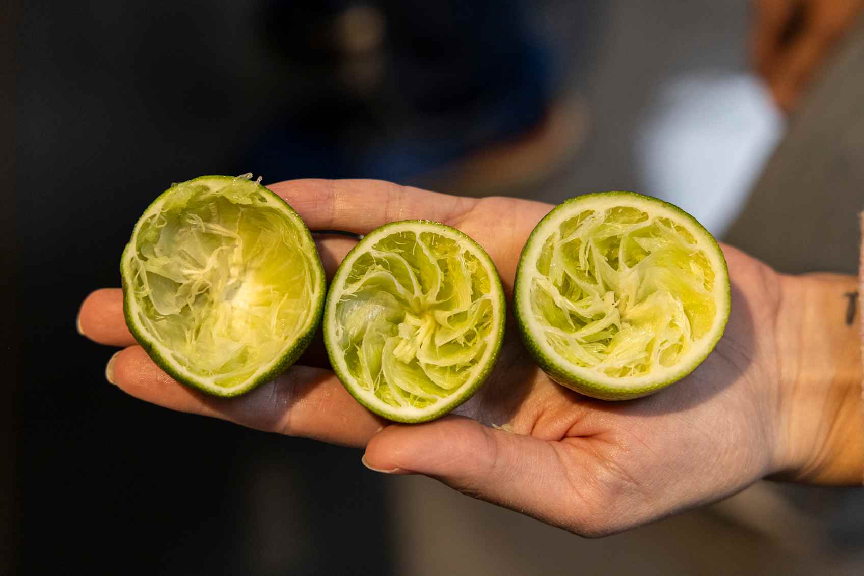 three spent lime halves in one hand