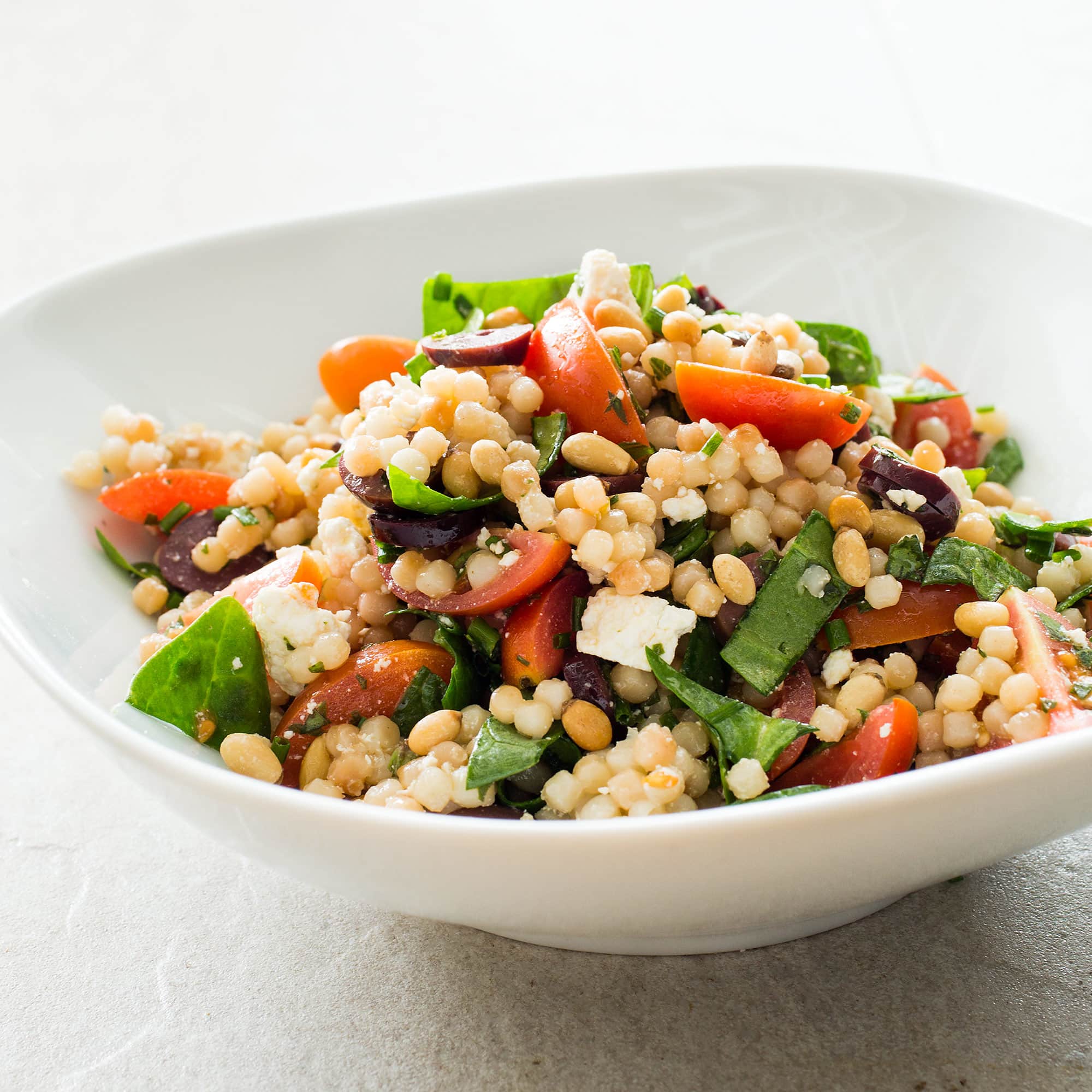 Pearl Couscous with Tomatoes, Olives, and Ricotta Salata | America's Test Kitchen