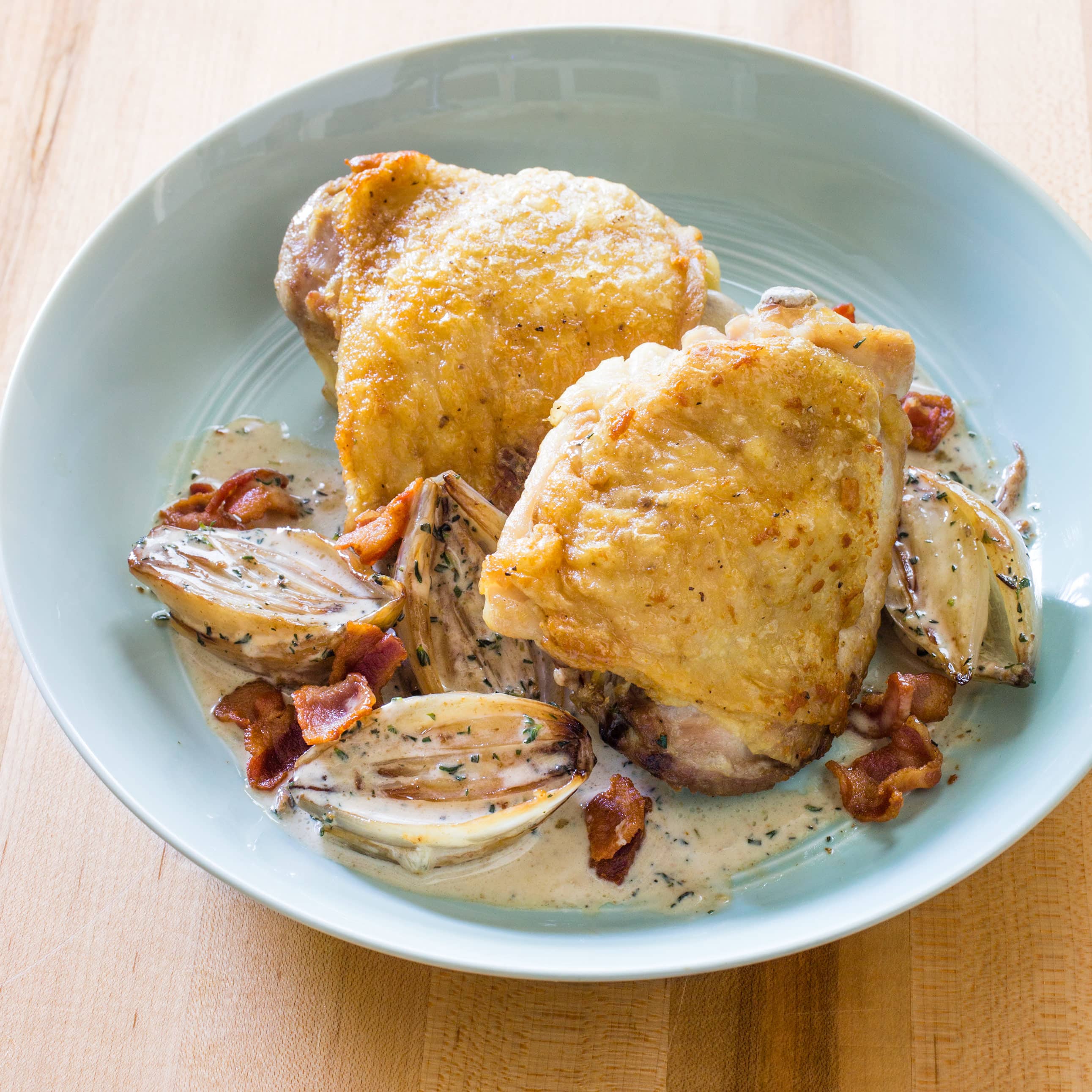 Roasted Chicken Thighs with Creamed Shallots and Bacon | America's Test Kitchen