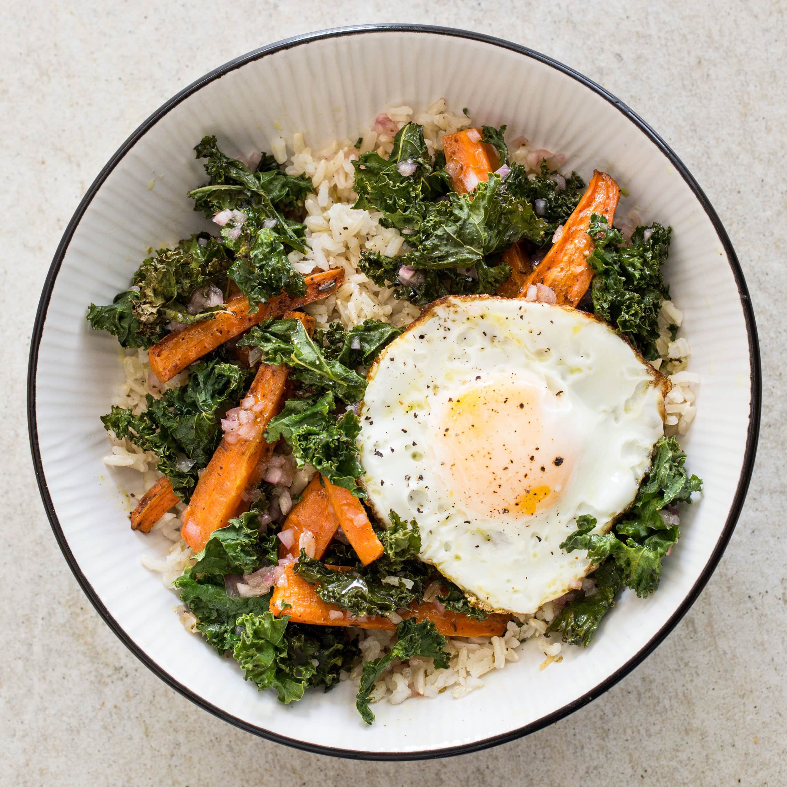 Gluten-Free Brown Rice Bowls with Roasted Carrots, Kale, and Fried Eggs | America's Test Kitchen