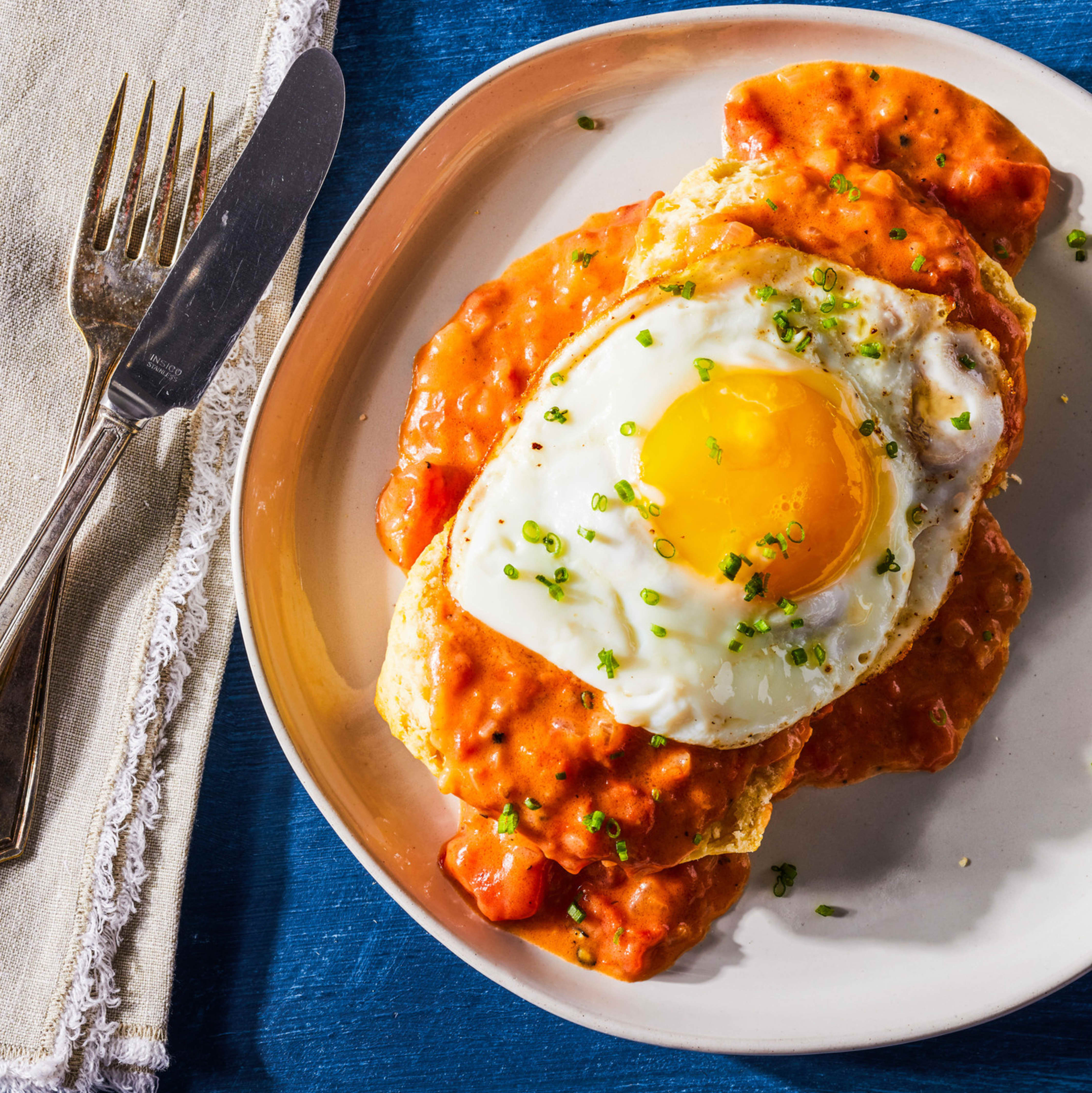Biscuits with Creamy Tomato Gravy and Fried Eggs