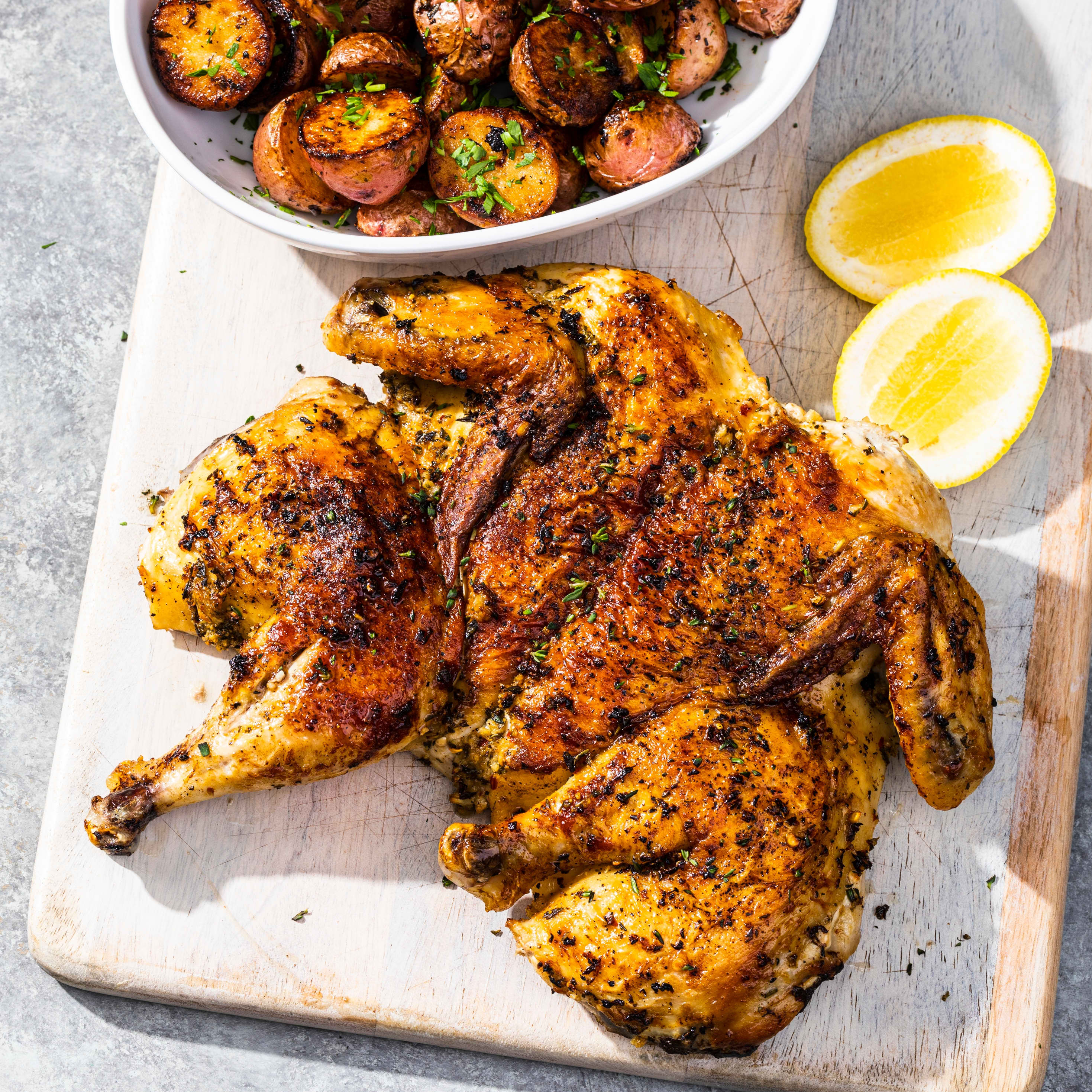 Chicken Under a Brick with Herb-Roasted Potatoes | America's Test Kitchen