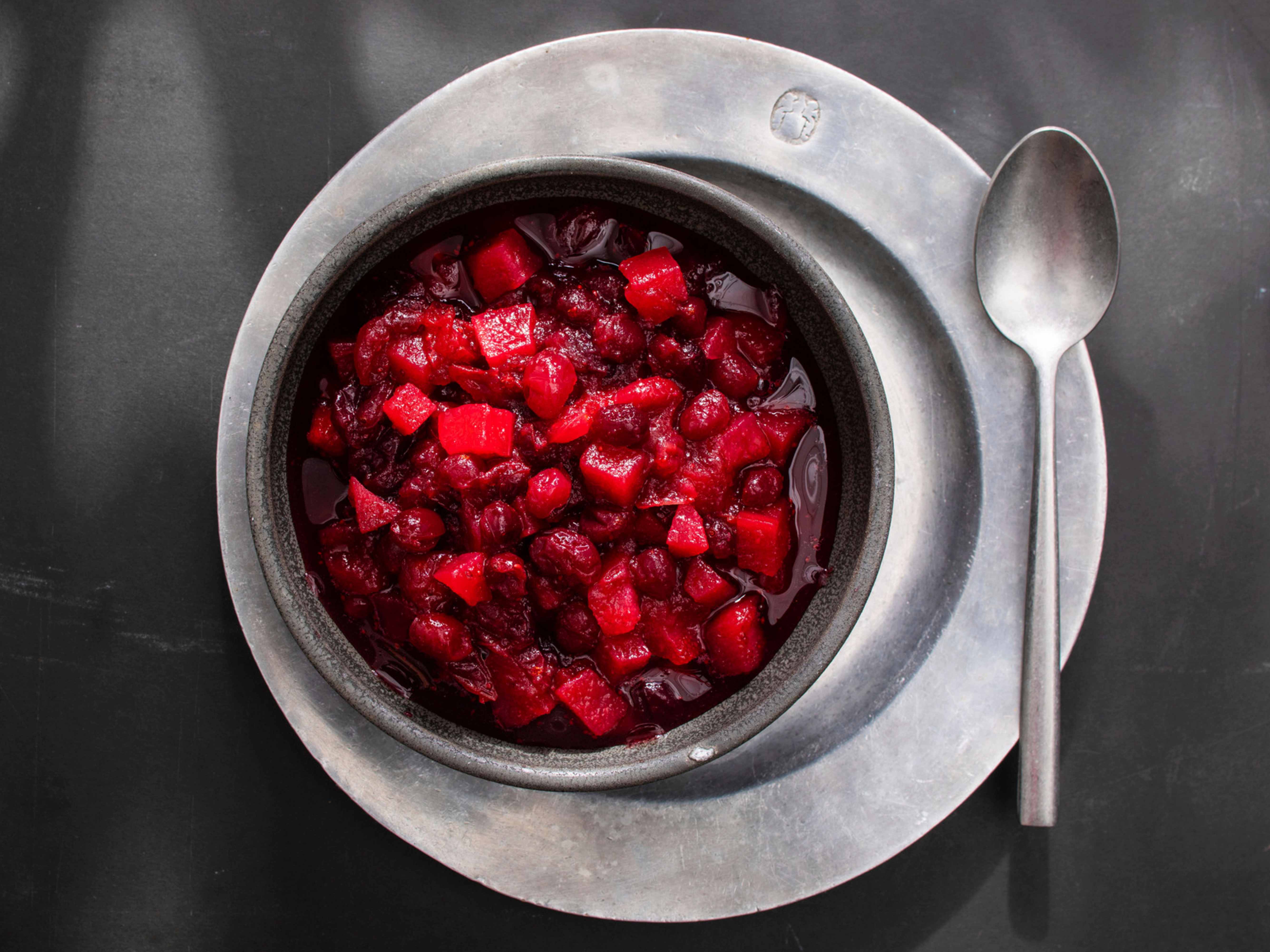 Cranberry sauce in a silver serving bowl with a spoon