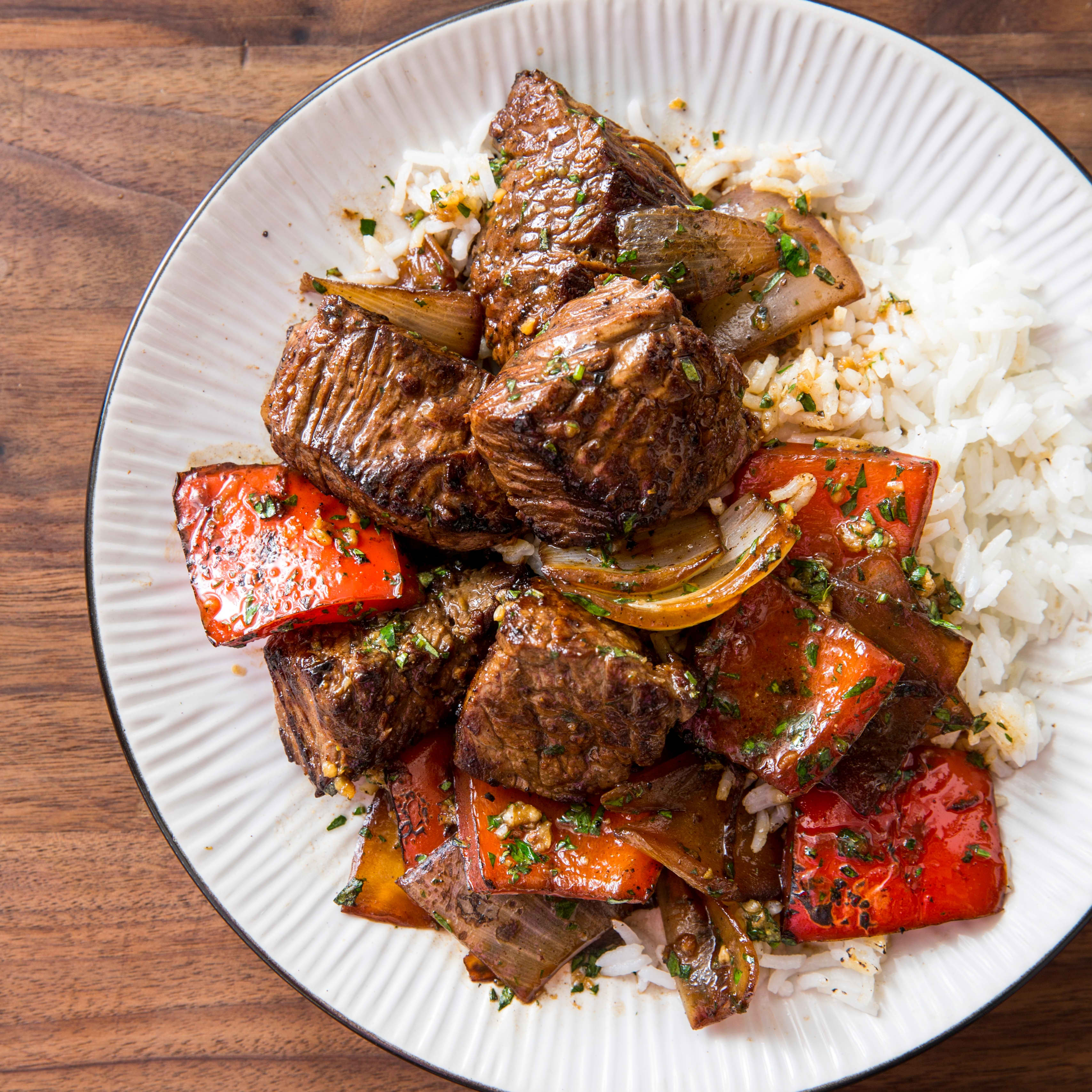Cast Iron Marinated Steak Tips with Charred Peppers and Onions