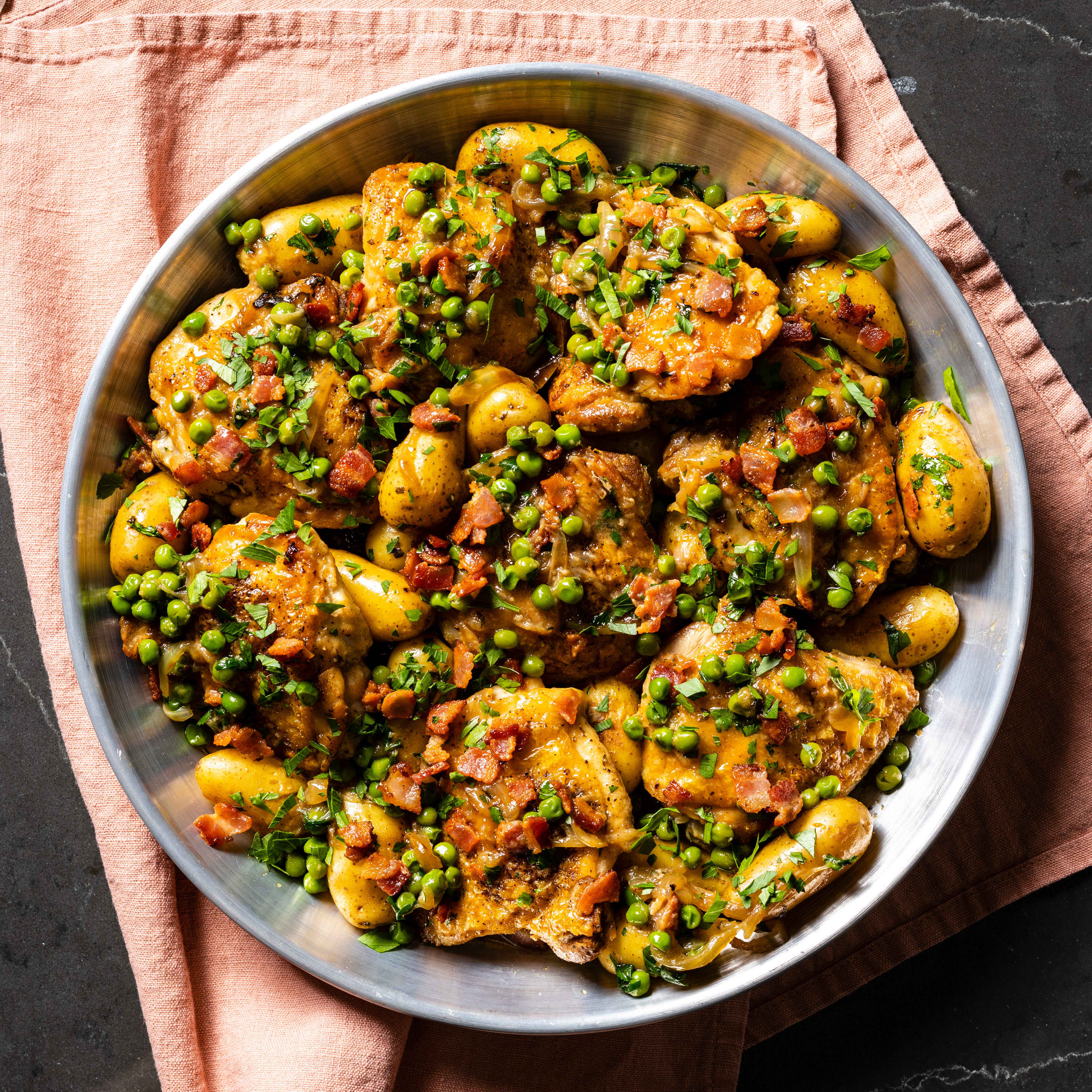 One-Pan Chicken Thighs with Fingerling Potatoes, Peas, and Bacon