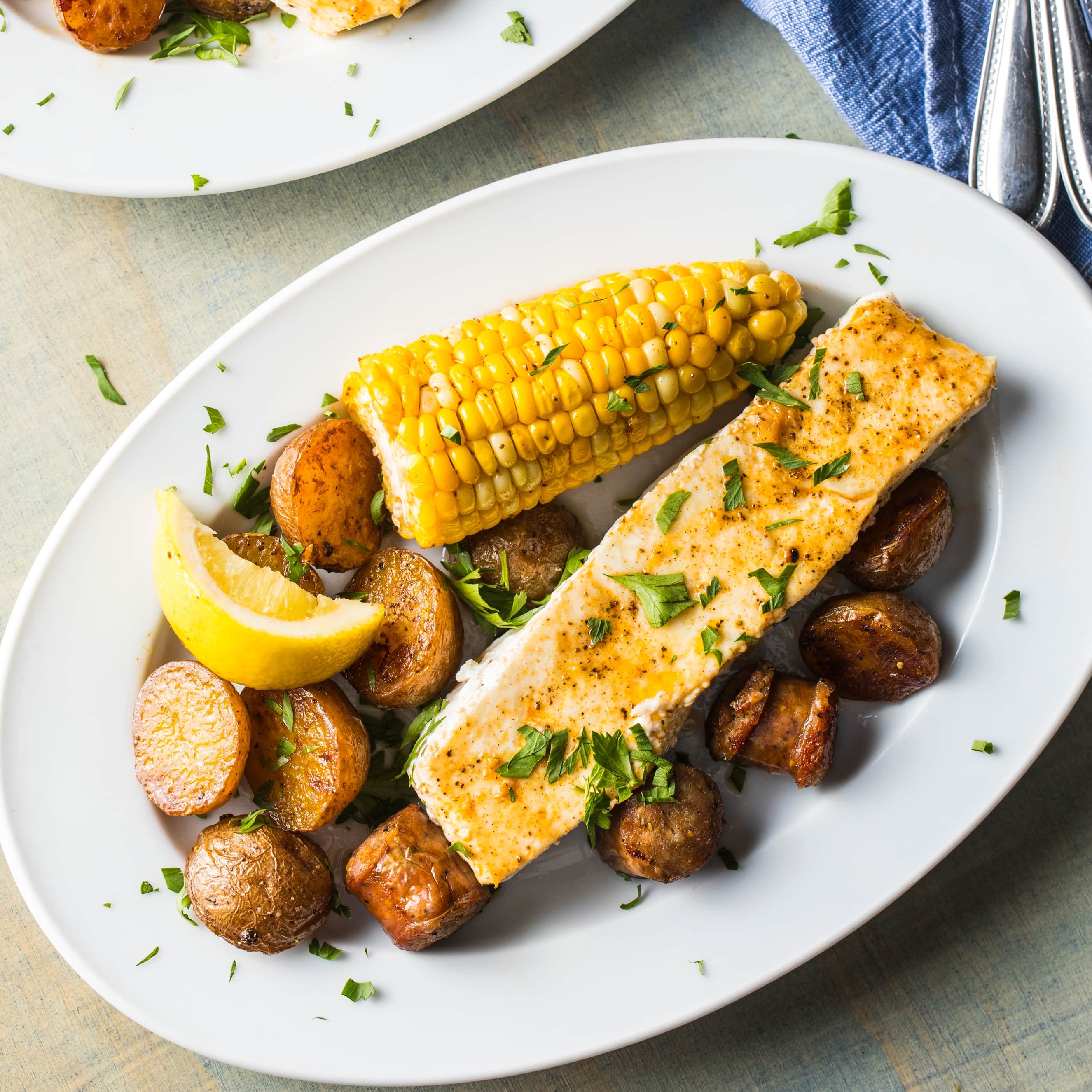 Toaster-Oven Roast Halibut with Red Potatoes, Corn, and Andouille | America's Test Kitchen