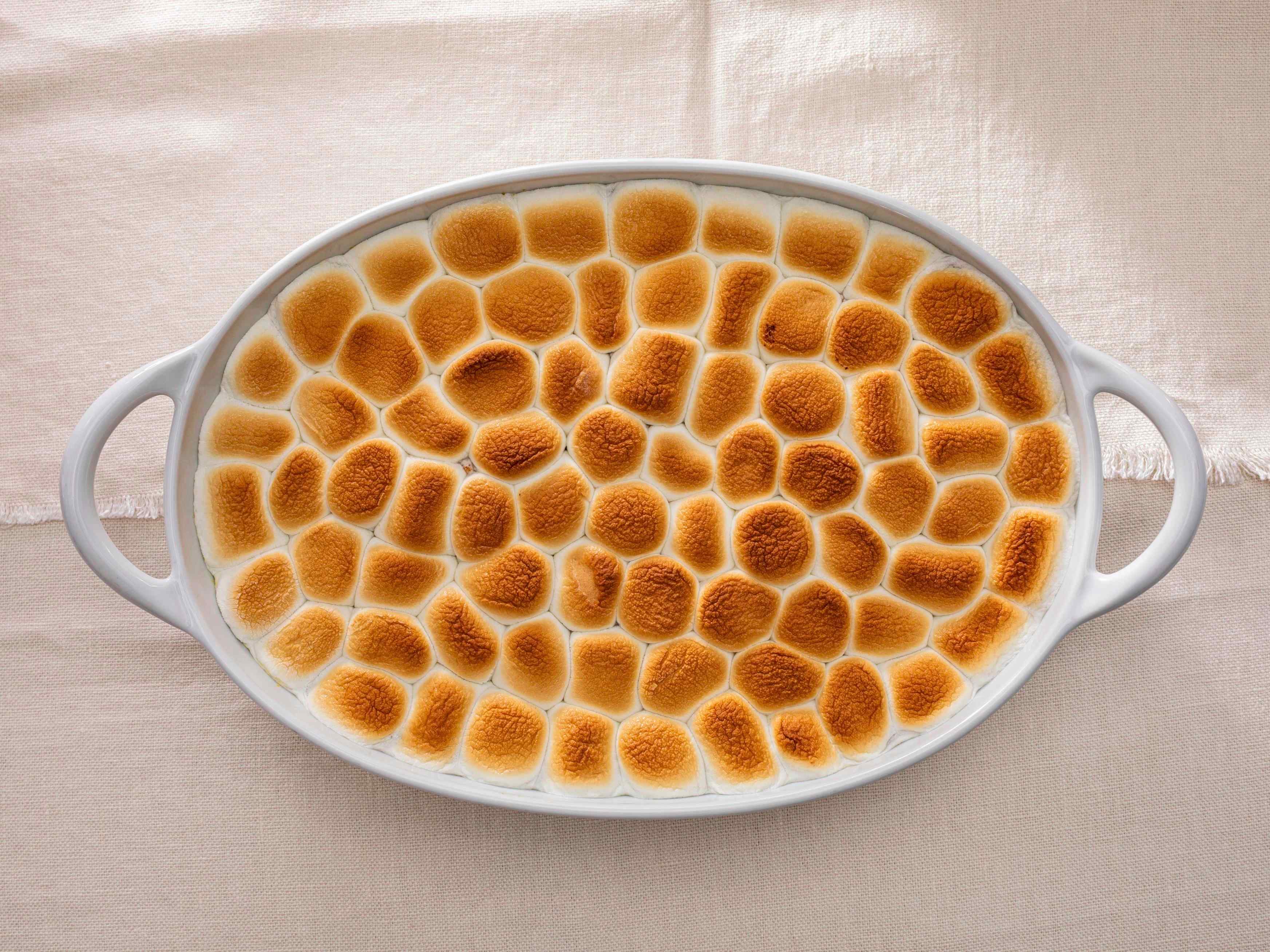 Sweet potato casserole with a marshmallow topping in a serving dish