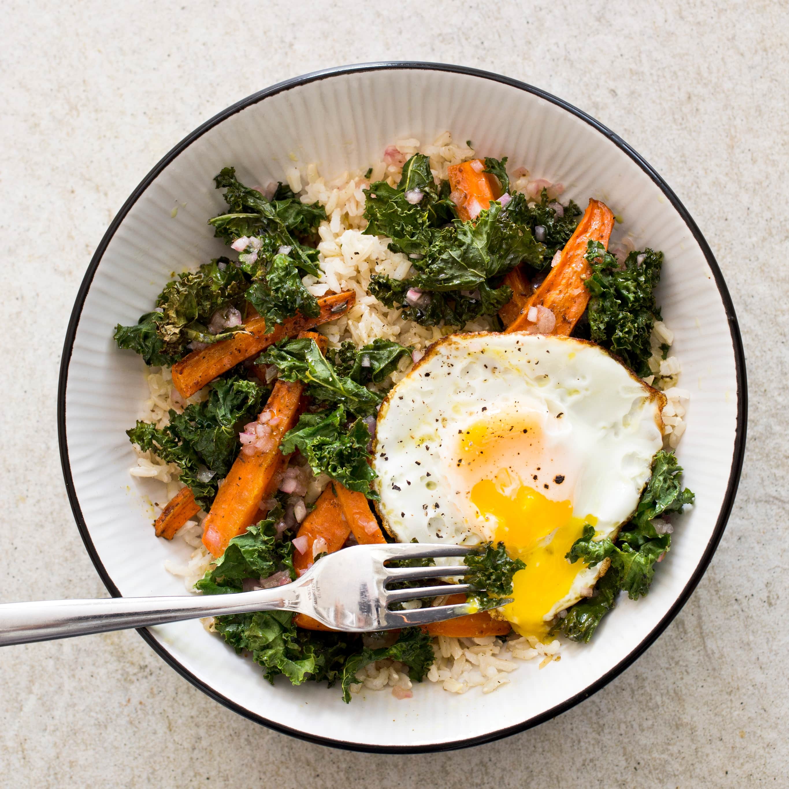 Brown Rice Bowl with Roasted Carrots, Kale, and Fried Eggs