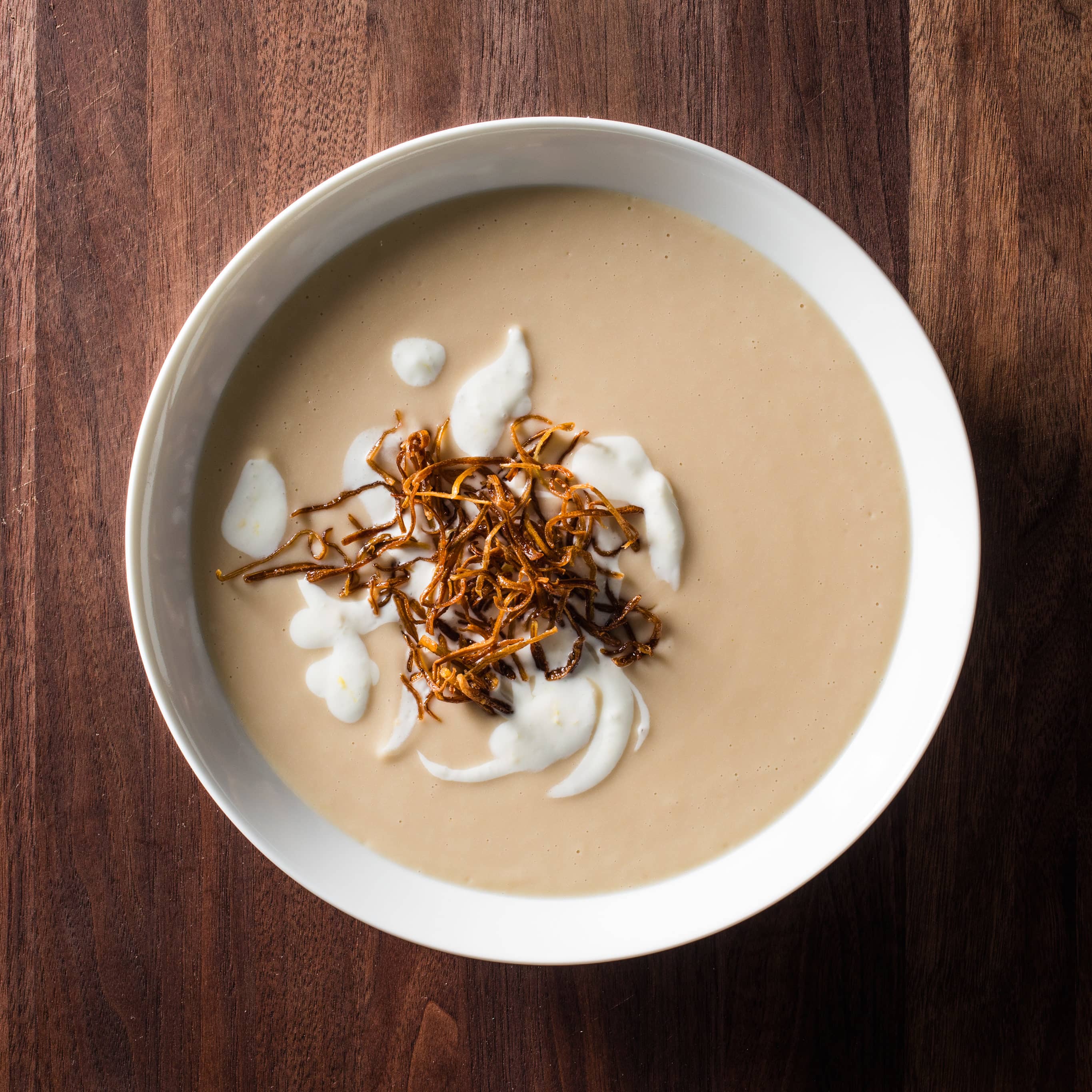 Creamy White Bean Soup with Lemony Yogurt and Crispy Leeks | America's Test Kitchen