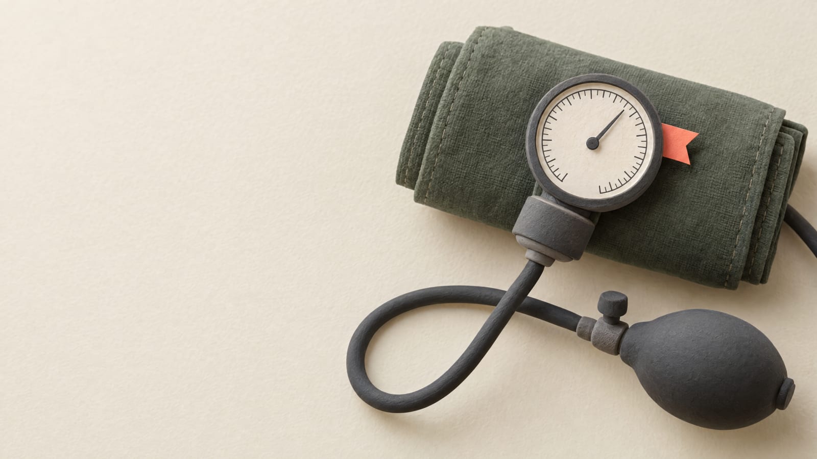 A blood pressure cuff and gauge with a small bright tab.