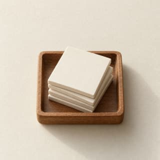 A wooden tray of blank letter tiles.