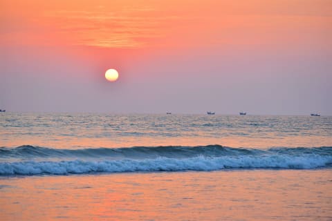 The sun setting over the waves at Cox’s Bazar