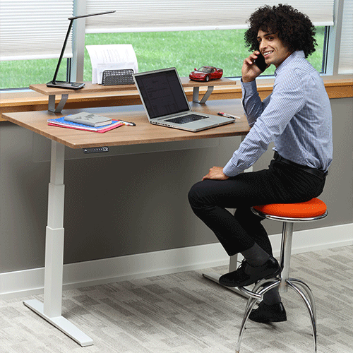 Man standing at 48 inch Adjustable Height Desk working from home