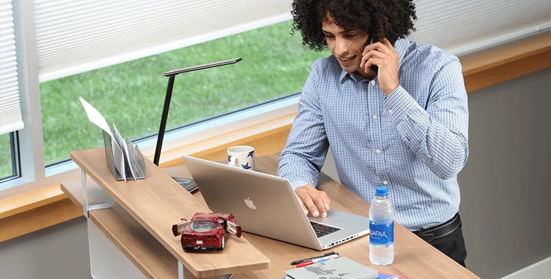 Man standing at SmartMoves Adjustable Height Desk