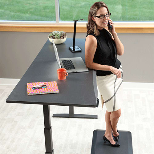 Woman standing at 72 inch Adjustable Height Desk working in office