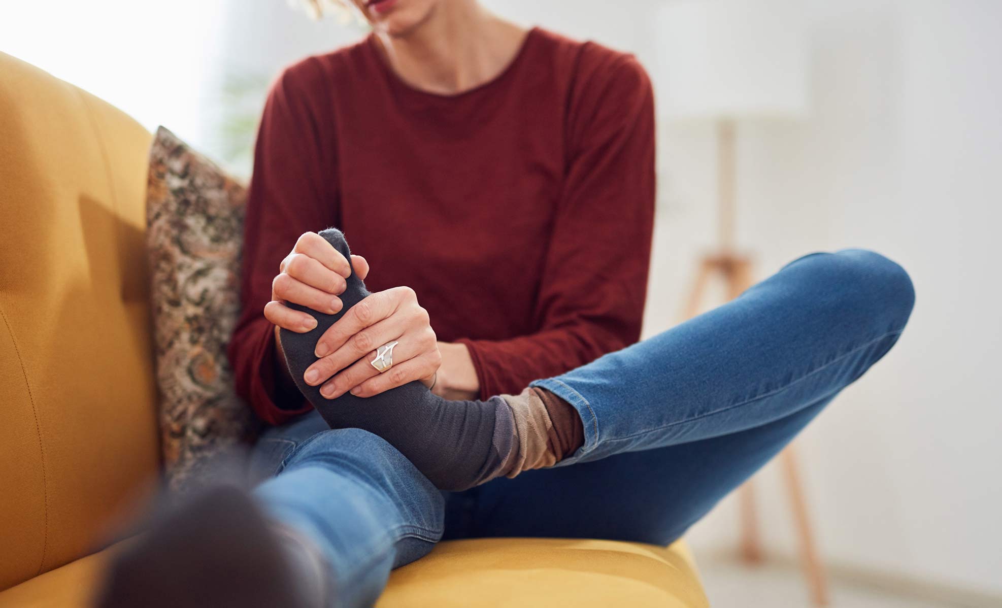 Woman holding foot in pain Woman holding foot in pain