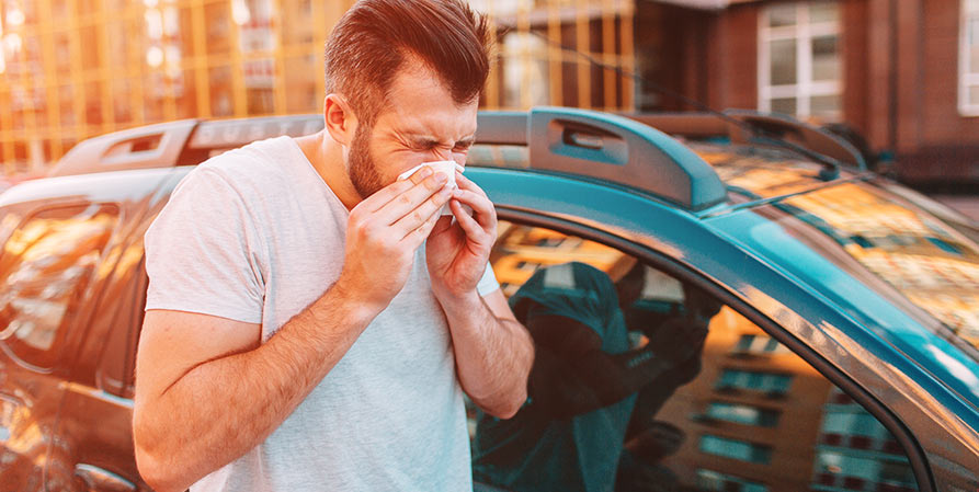 man blowing his nose