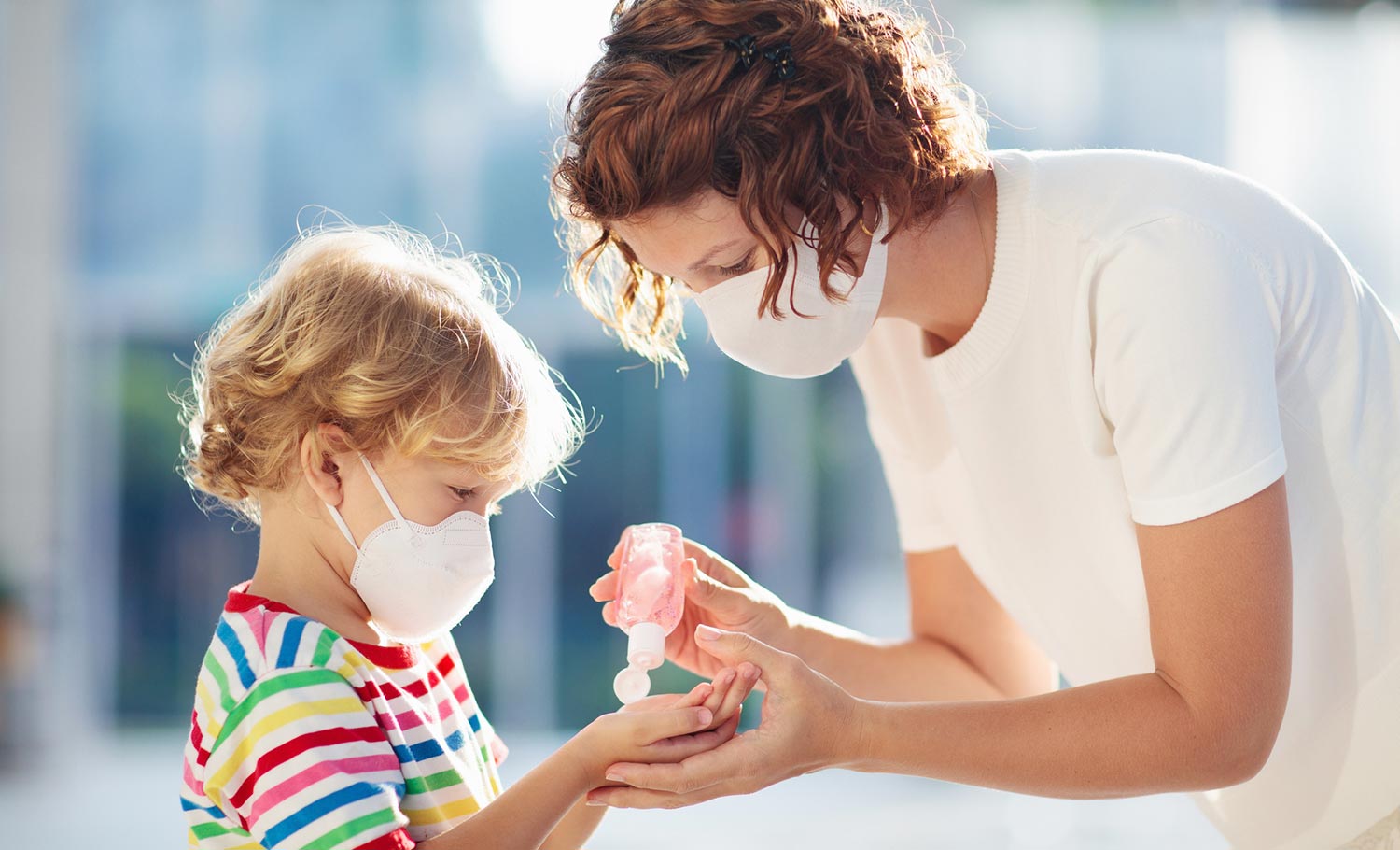 giving a child hand sanitizer