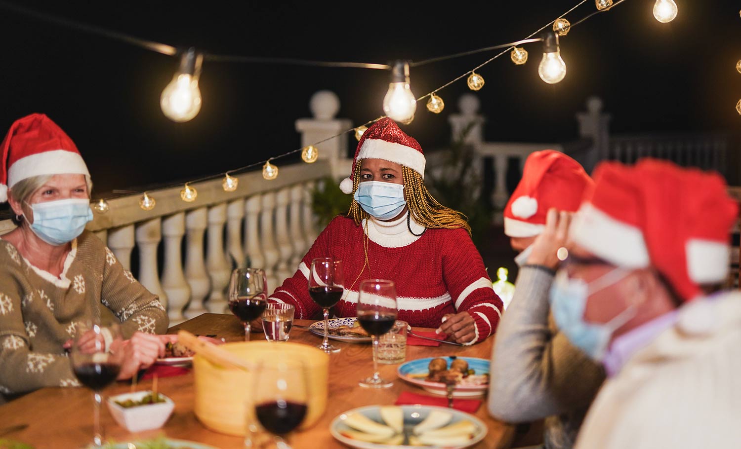 friends having dinner with masks